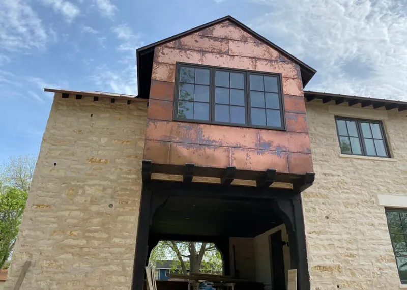 Copper metal panel facade on a stone building for Metal Roof Coating in Waukegan