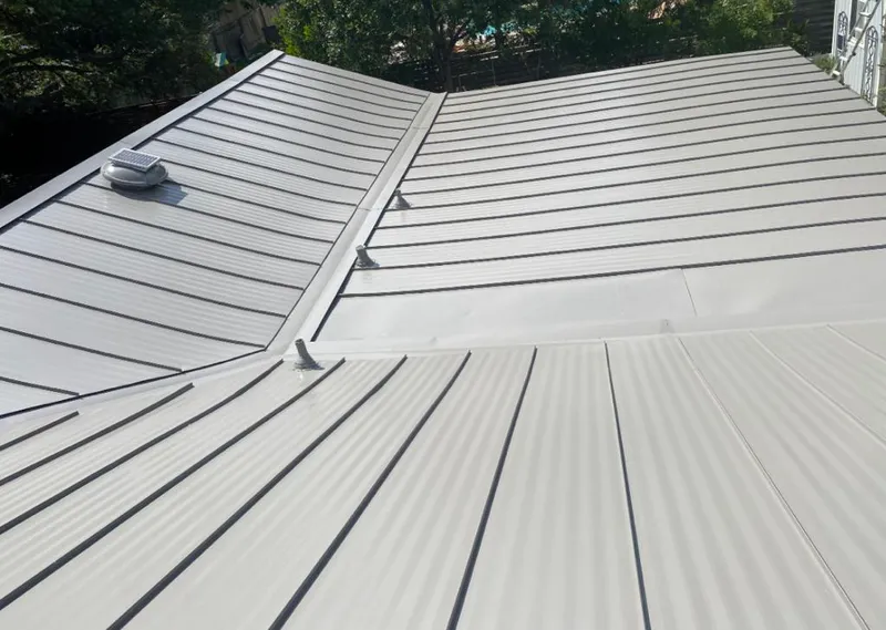 Solar attic fan installed on a metal roof for Roof Ventilation in Waukegan